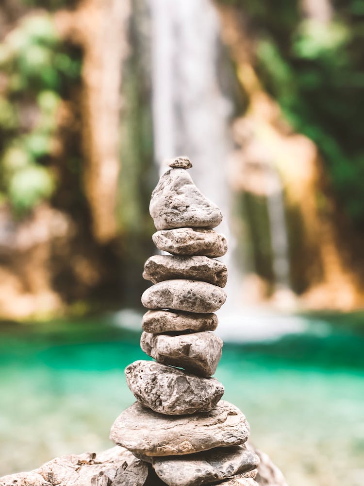 Stack Of Rocks In Front Of A Waterfall