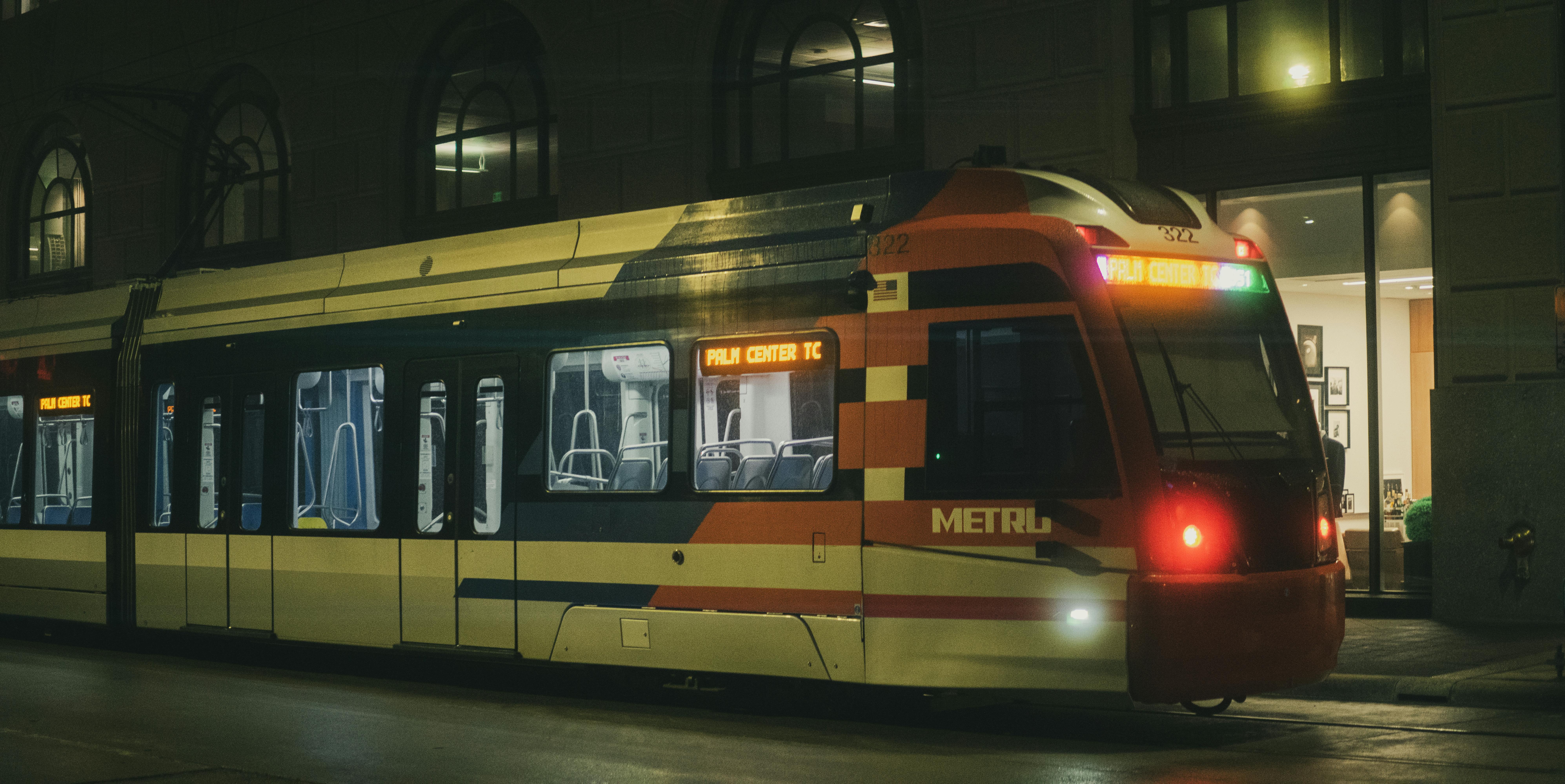 A METRO train in Houston at night, showcasing urban transportation in the city's downtown area.