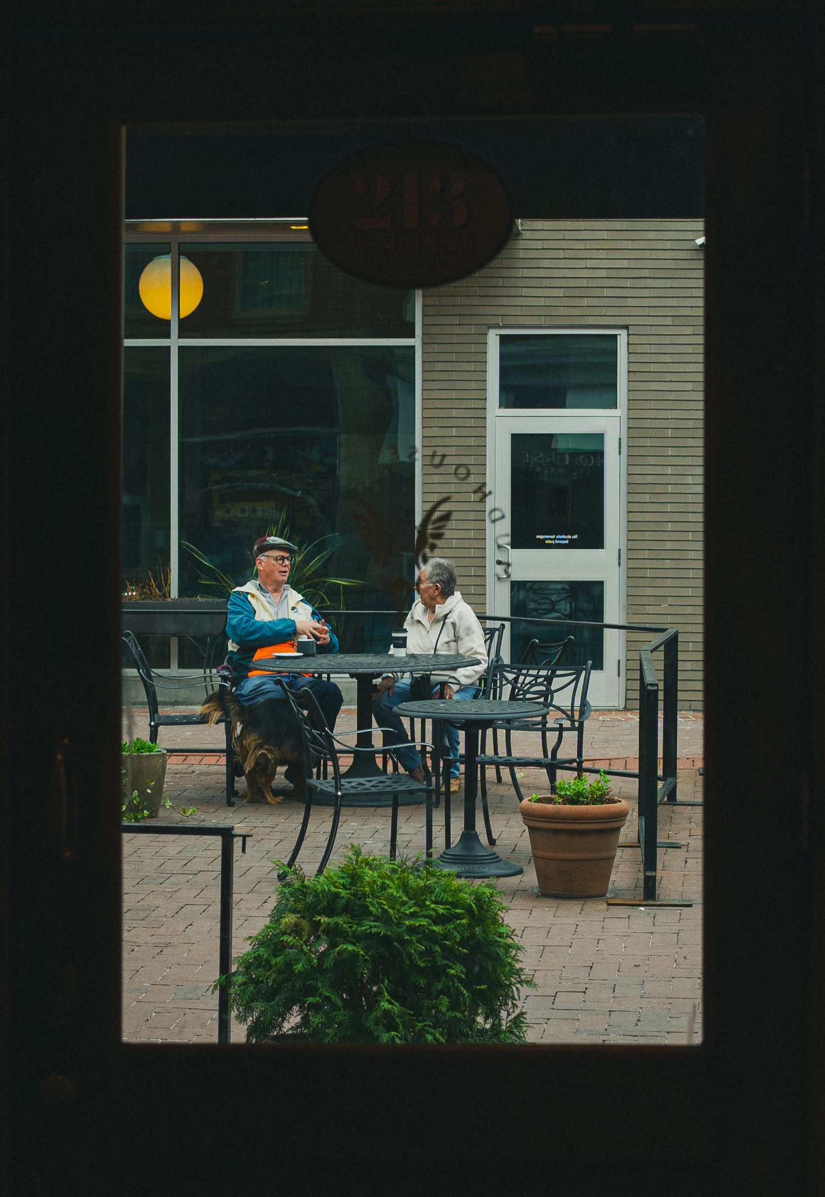 Two people conversing outside a cafe in Charlottesville, Virginia.