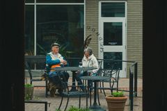Two people conversing outside a cafe in Charlottesville, Virginia.