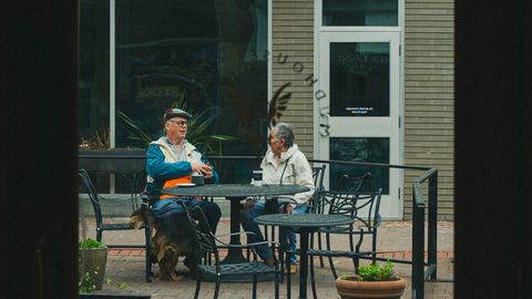 Two people conversing outside a cafe in Charlottesville, Virginia.