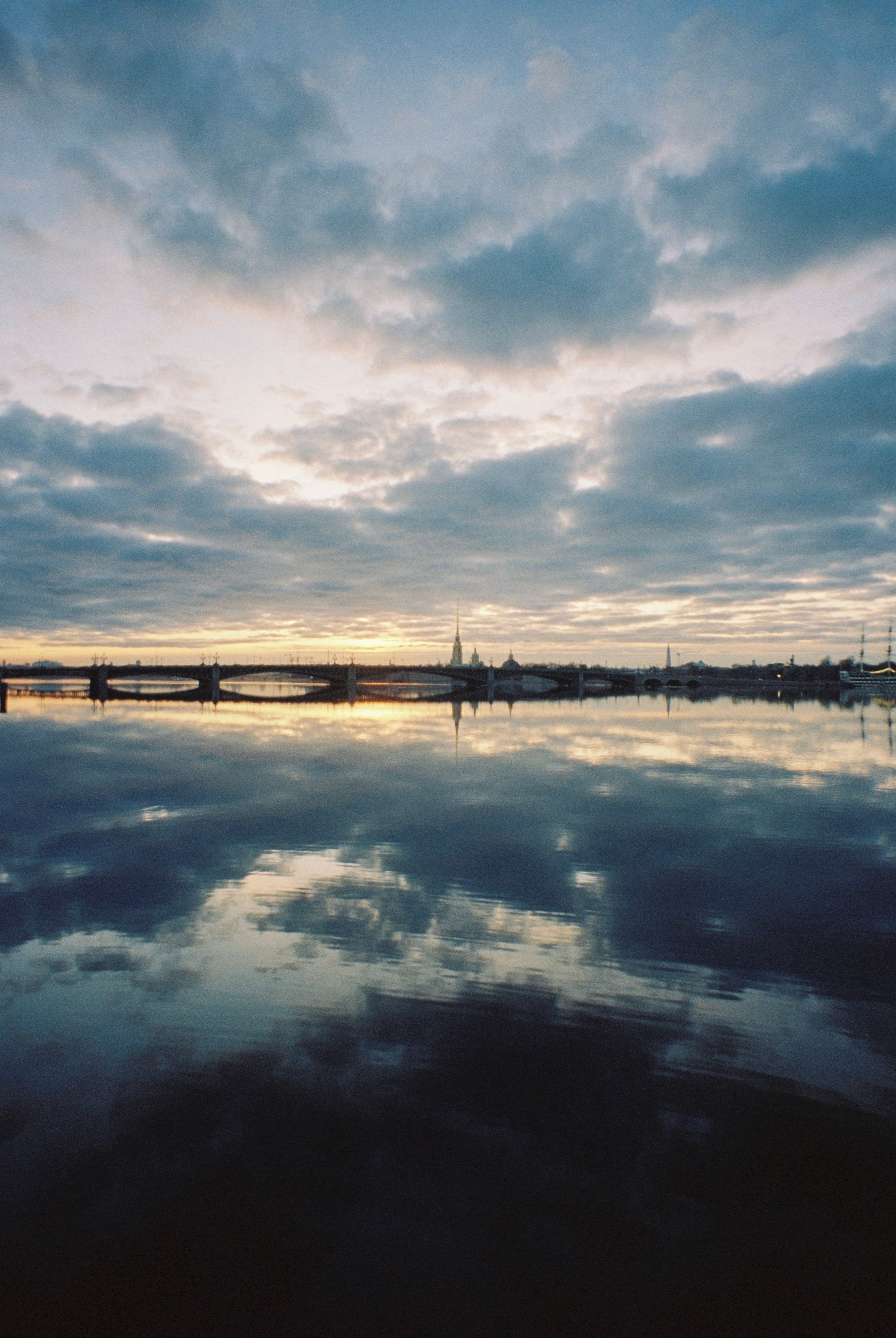 Serene Sunset Over Calm Urban Waterfront · Free Stock Photo