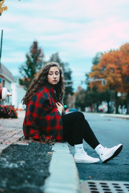 Woman Sitting on Crub