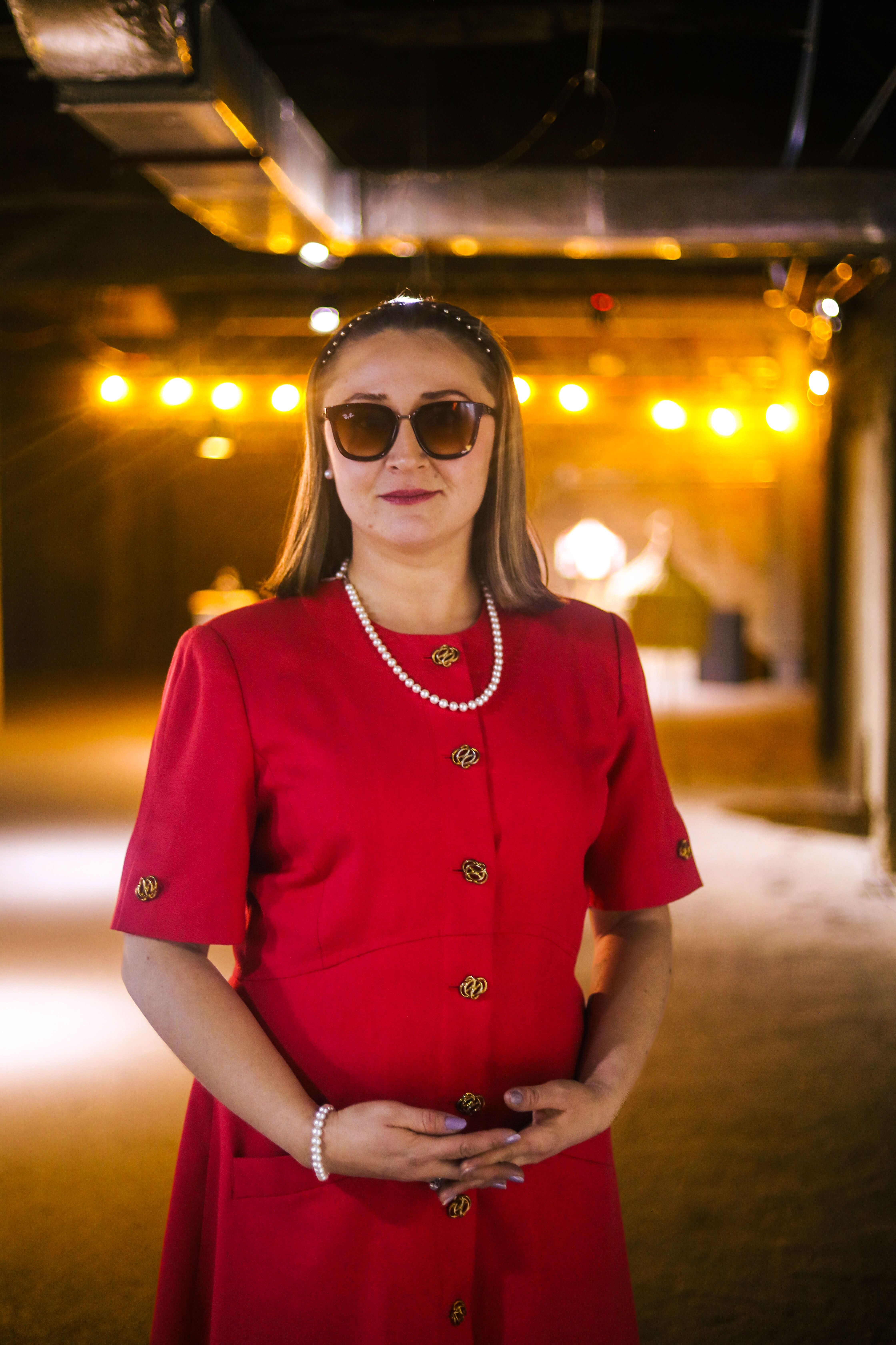 Elegant Woman in Red Dress Indoors with Warm Lighting · Free Stock Photo