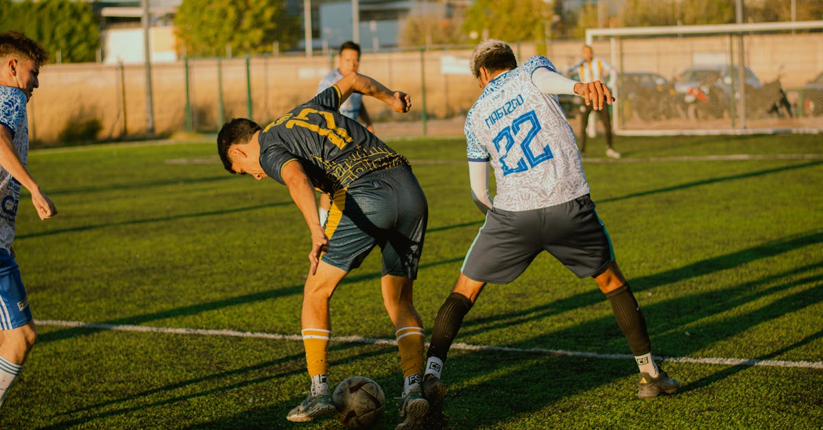 Players compete passionately in a soccer match on a sunny outdoor field.