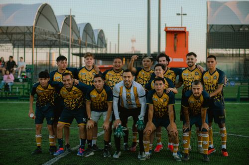 Free A soccer team poses together on a grassy field during daytime. Stock Photo