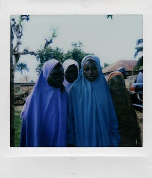 A group of young girls in colorful hijabs standing outdoors, showcasing cultural diversity and unity.