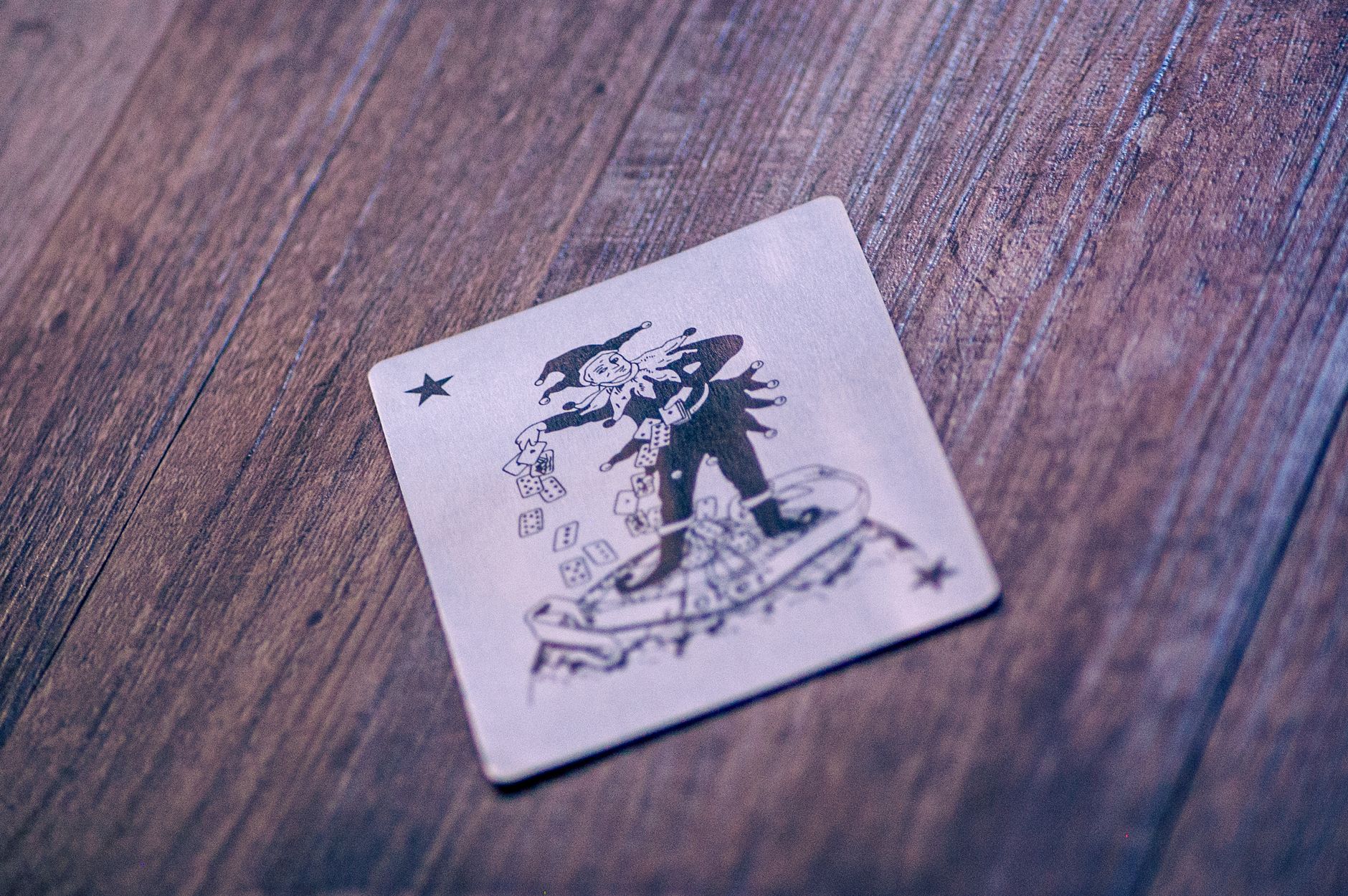 A Joker playing card lies on a textured wooden surface, creating a classic gaming vibe.