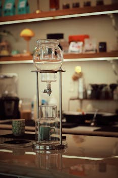 Elegant coffee brewing setup in a warm, cozy cafe interior.