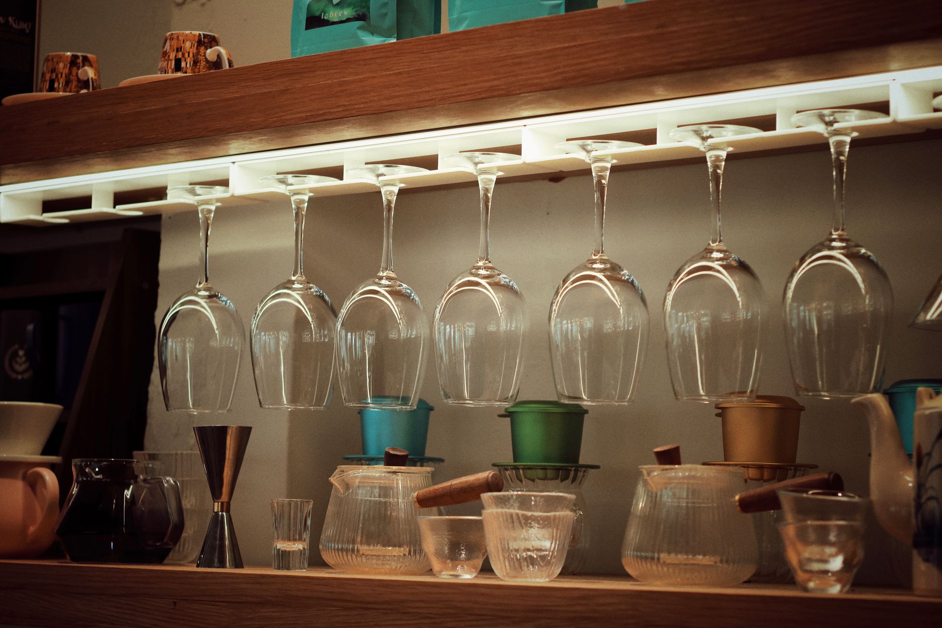 Elegant coffee bar setup with inverted wine glasses and brewing tools.
