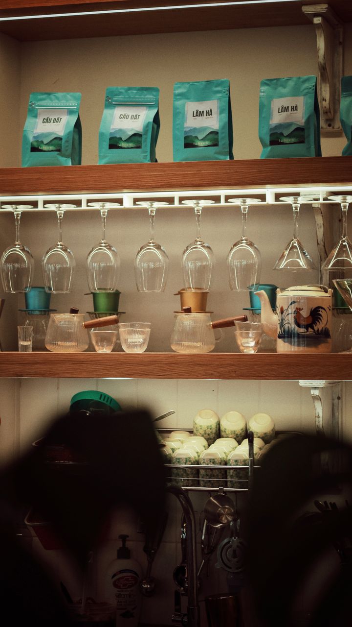 Rotating ceramic mug tree stand holding colorful mugs on a dollar tree coffee bar design
