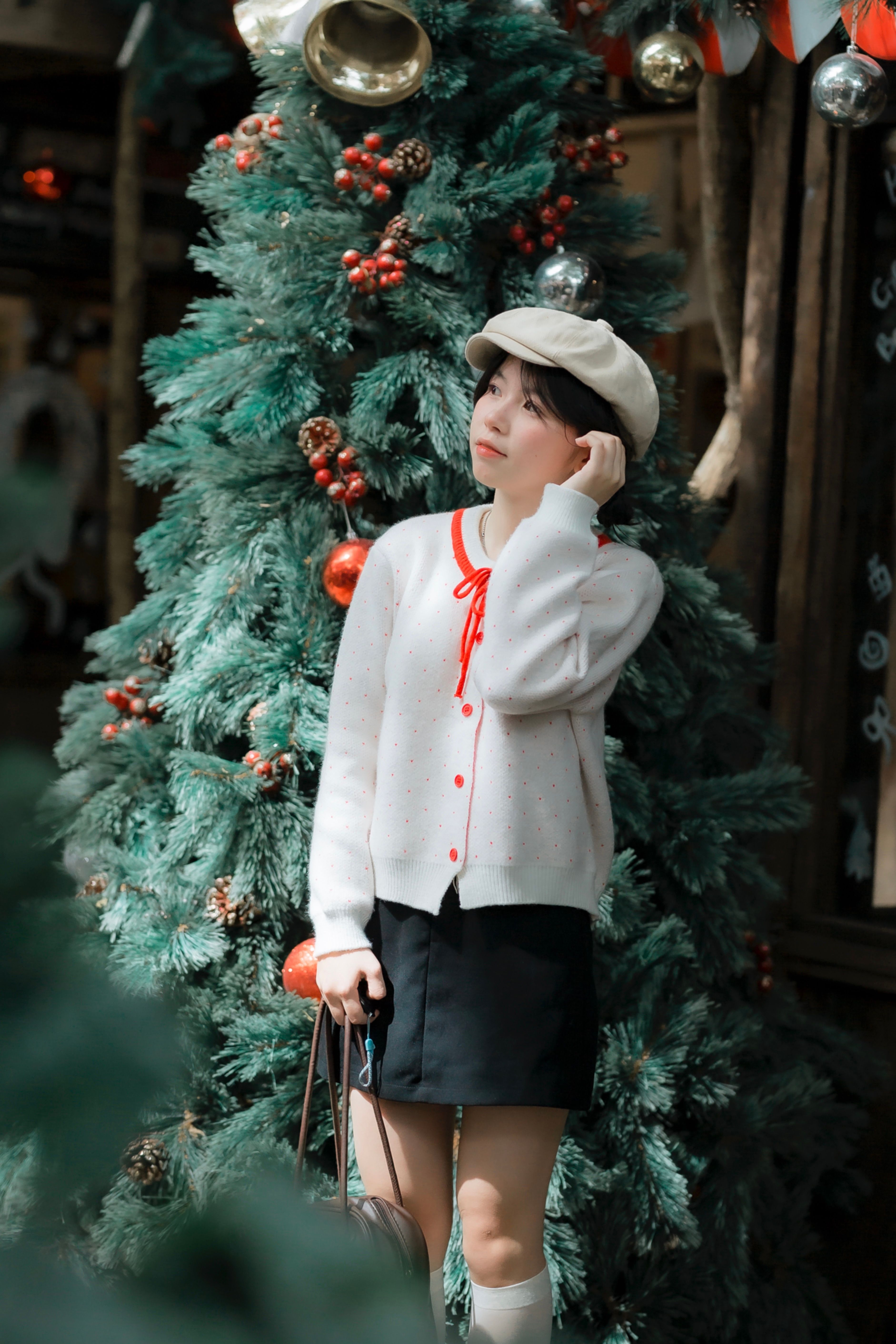 Woman Posing by Decorated Christmas Tree Outdoors · Free Stock Photo