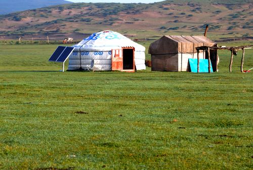 Free A traditional Mongolian ger with solar panel in a vast grassy landscape, perfect for eco-living themes. Stock Photo