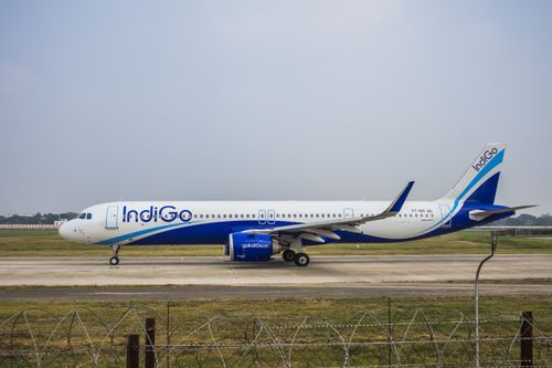 Free IndiGo Airbus A320 ready for takeoff at airport runway, clear sky. Stock Photo