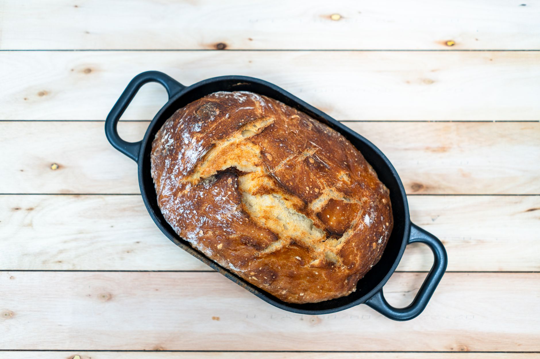 Cast iron Dutch oven with cooked chicken and vegetables