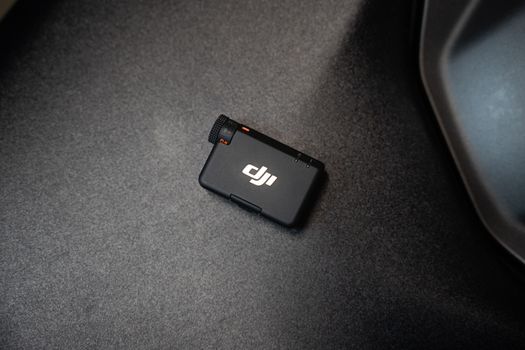 Top view of a compact action camera placed on a dark surface, emphasizing modern design.