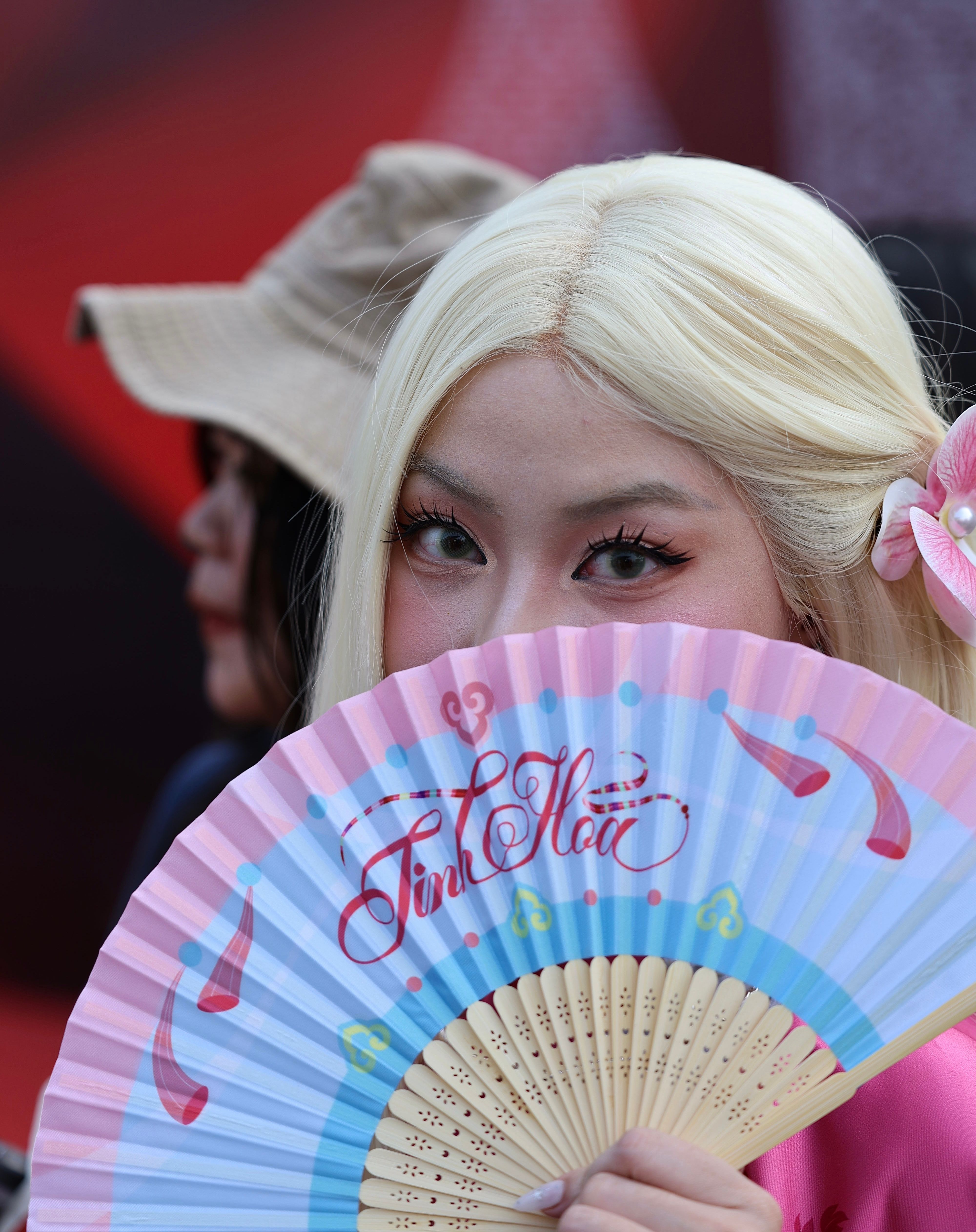 Woman with Fan at Outdoor Cultural Event · Free Stock Photo