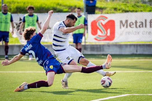 Intense soccer tackle with players in action, showcasing teamwork and competition on the field.