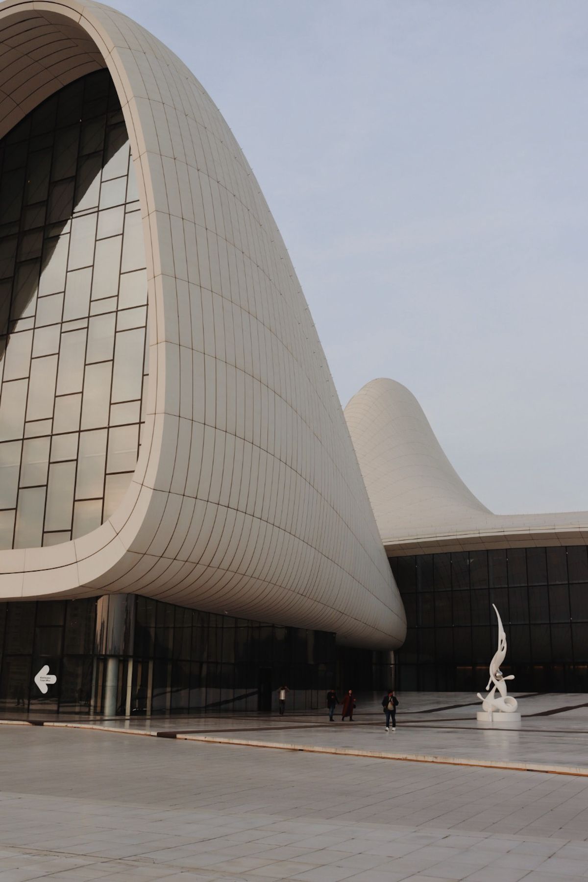 Sweeping white curved pavilion roof against a clear sky