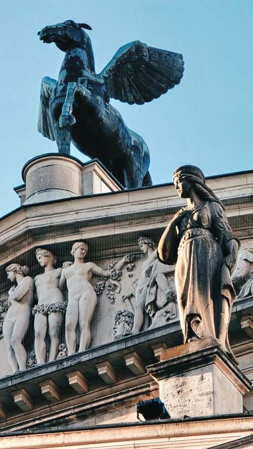 Free Close-up of detailed historical architecture featuring a Pegasus sculpture and classic statues Stock Photo