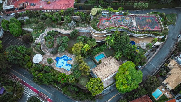 A unique aerial shot of a vibrant rooftop garden with pools and colorful paths.