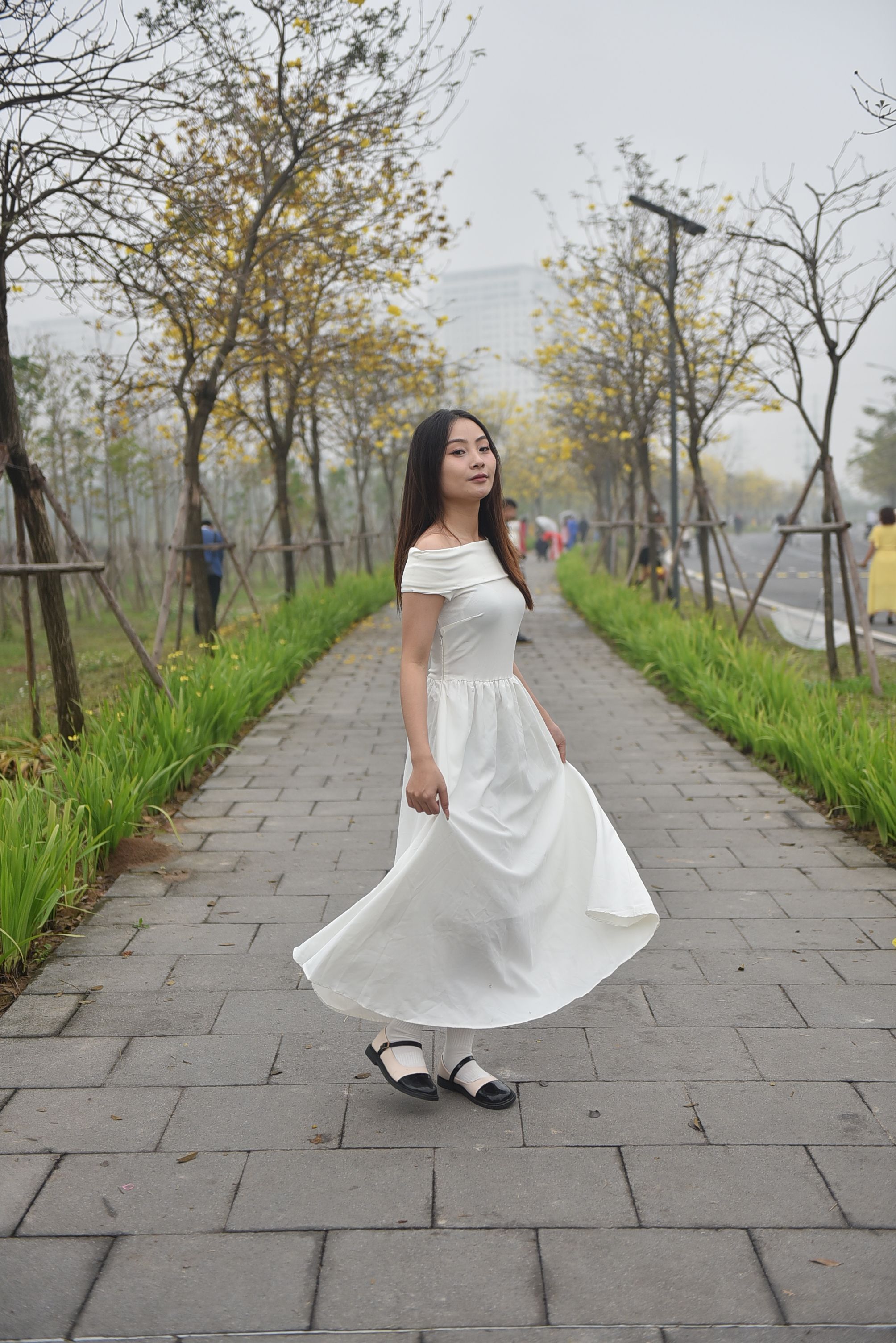Elegant Woman Strolling in a Park Pathway · Free Stock Photo