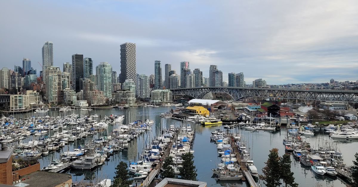 View of Vancouver marina with skyline and Burrard Street Bridge.