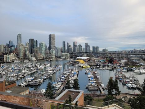 View of Vancouver marina with skyline and Burrard Street Bridge.