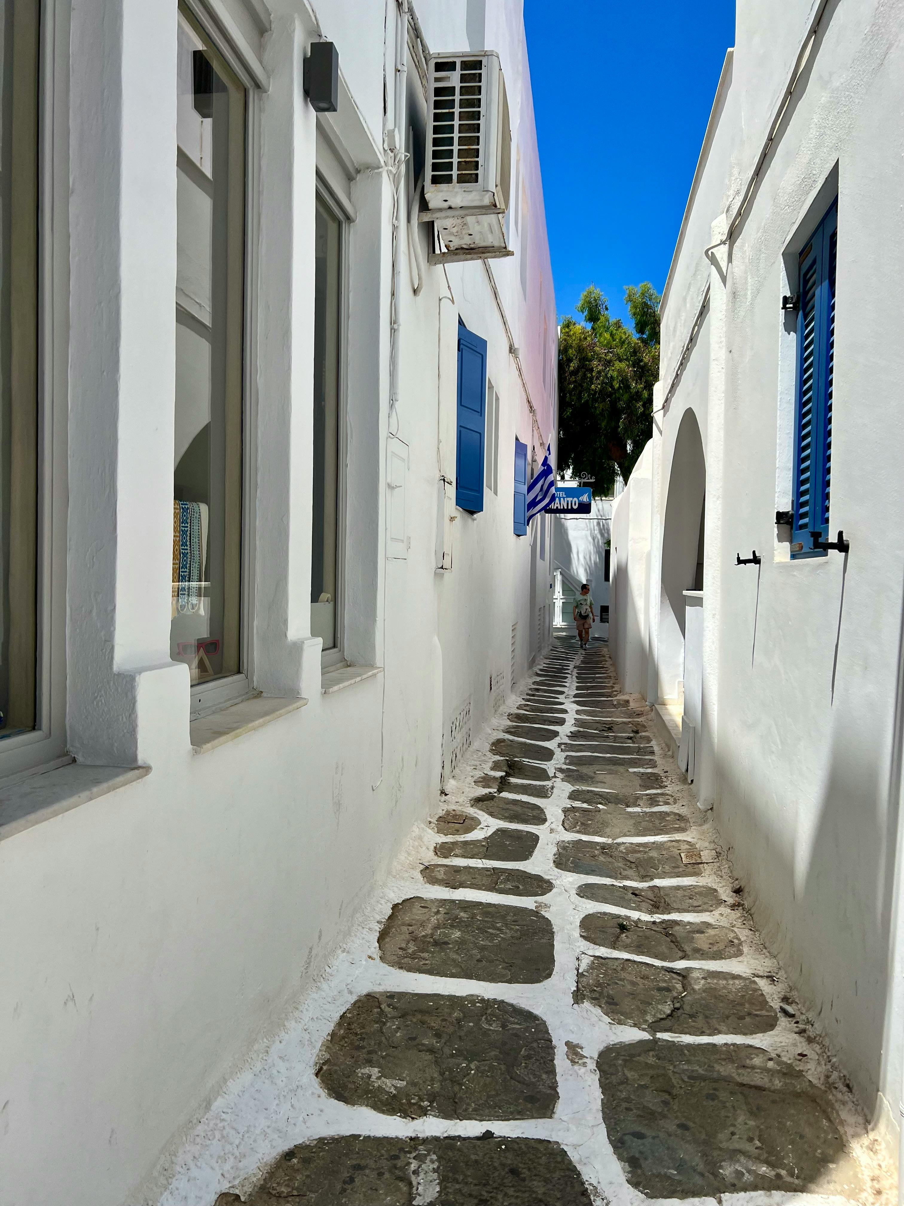 A charming narrow whitewashed street in Mykonos, Greece
