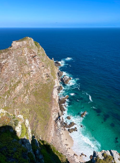 Free Spectacular aerial view of Cape Point's rugged cliffs and azure ocean in South Africa. Stock Photo