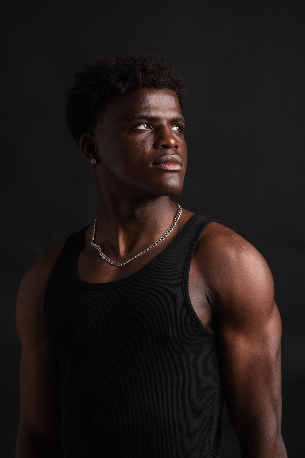 Top Strong Model Strong Male Model Posing in Dark Studio Setting · Free Stock Photo