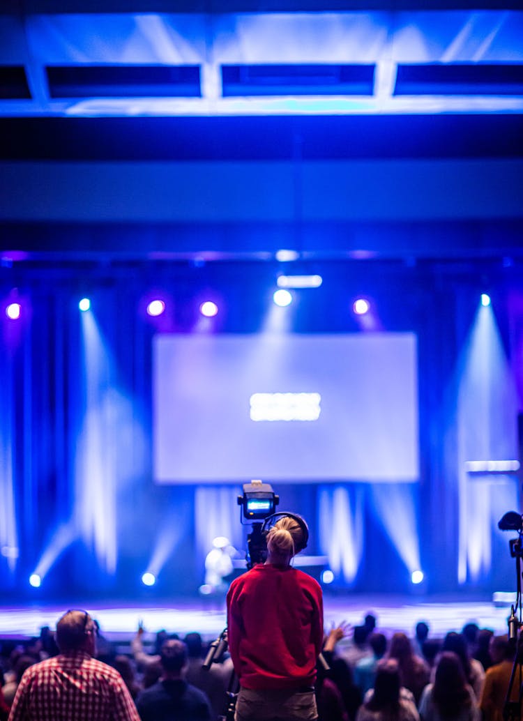 Shallow Focus Photo Of Camera Man In Red Jacket