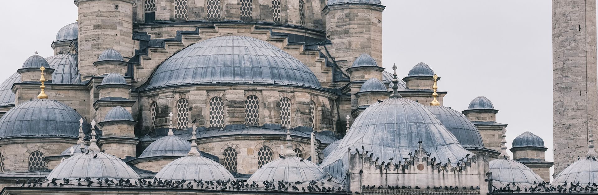 Close-up view of ornate dome architecture on a historical mosque, showcasing detailed Islamic design