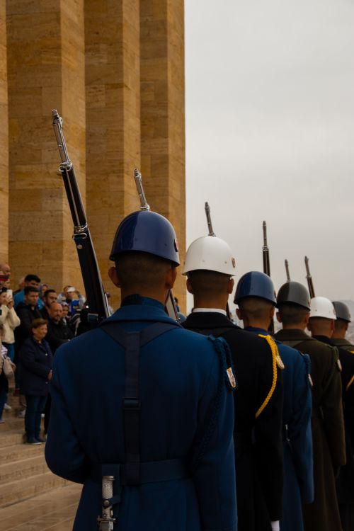 Free Ceremonial guards in uniform stand at attention during a formal event with onlookers. Stock Photo