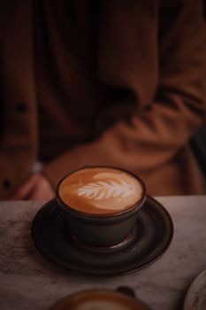 Warm cafe setting with latte art, perfect for coffee lovers.