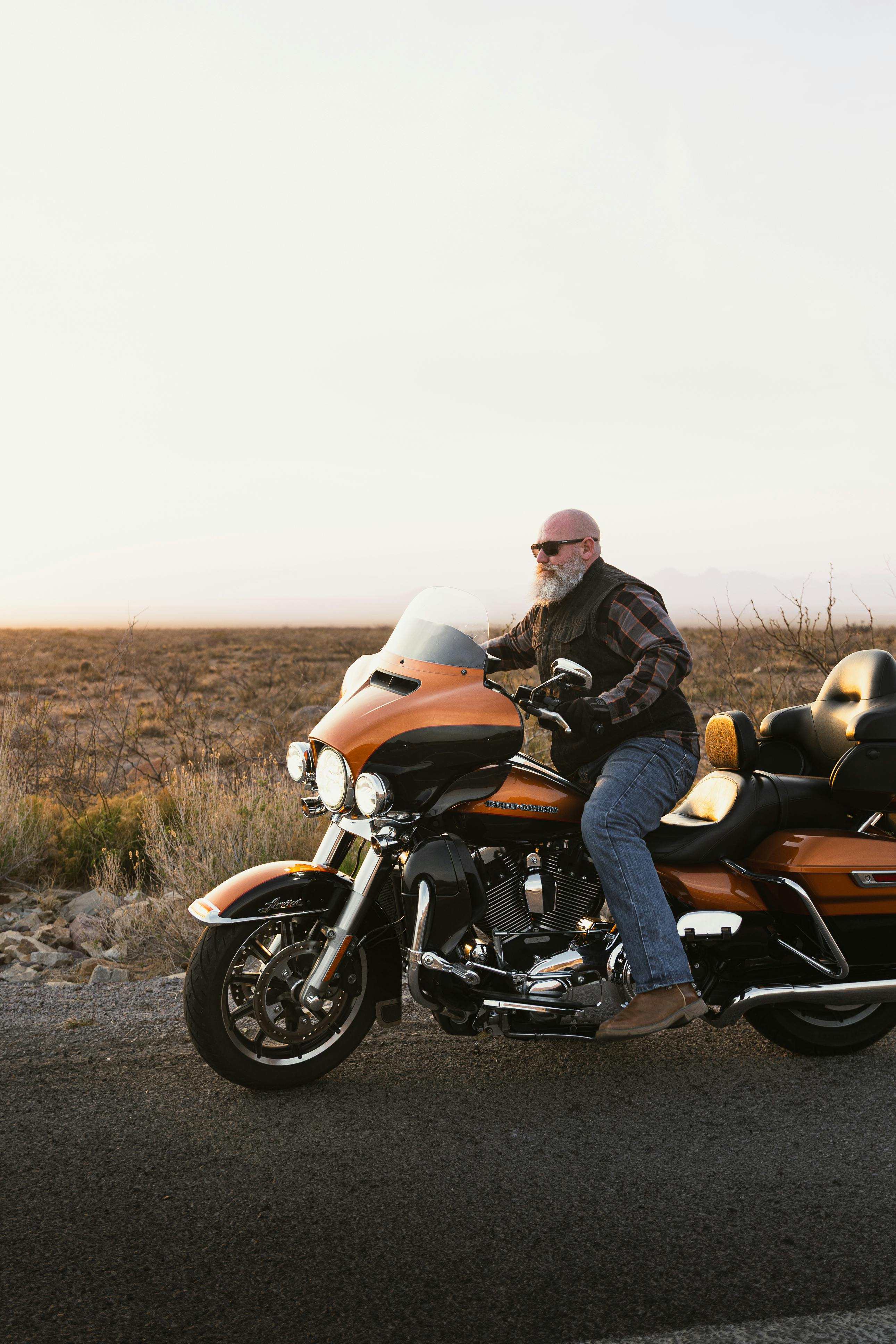 A biker enjoys a sunset ride on a Harley-Davidson along a New Mexico highway.