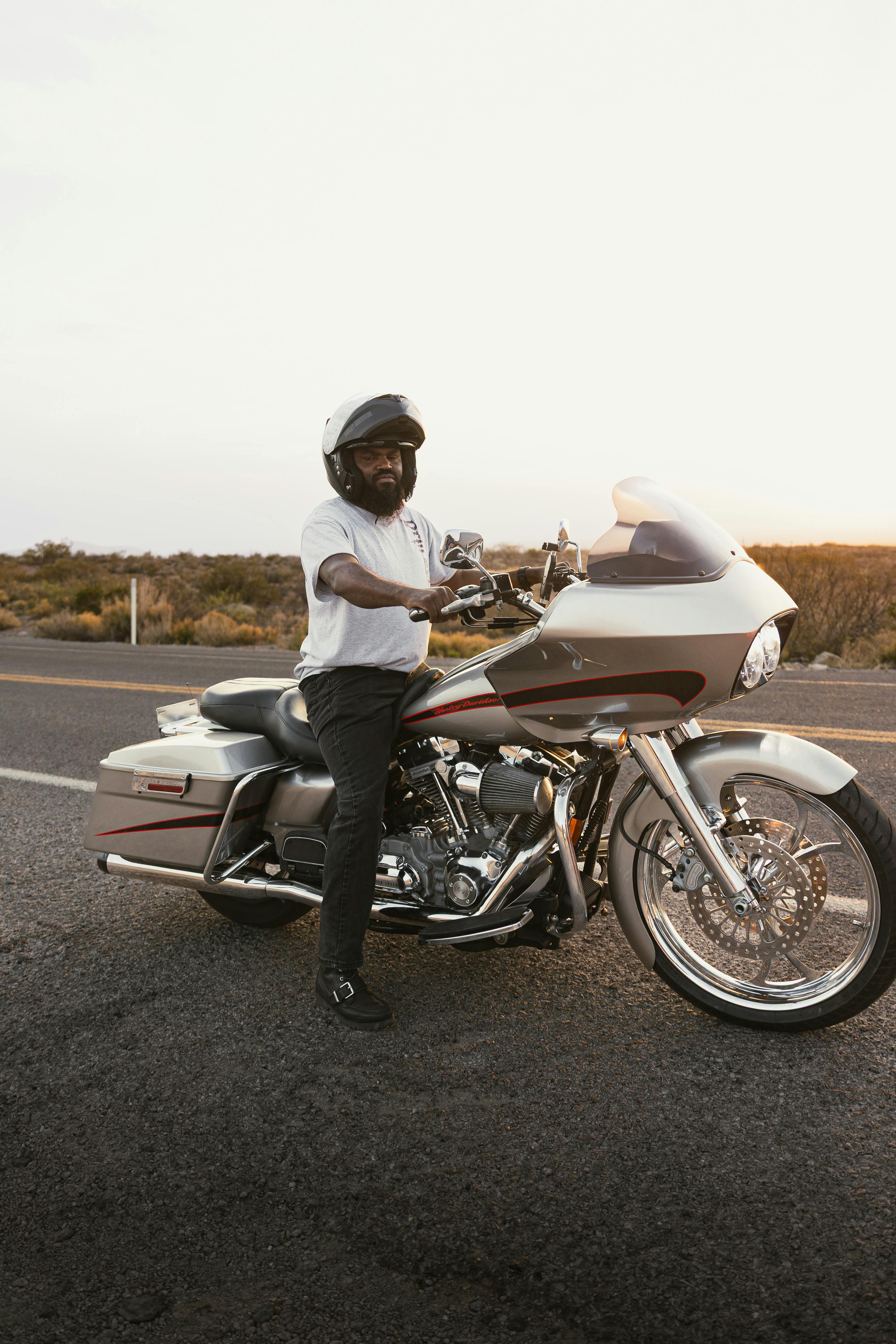 Biker on a Harley-Davidson enjoying a sunset ride on Route 66 in New Mexico.