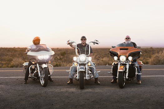 Three bikers on motorcycles riding on a scenic road during sunset in New Mexico.