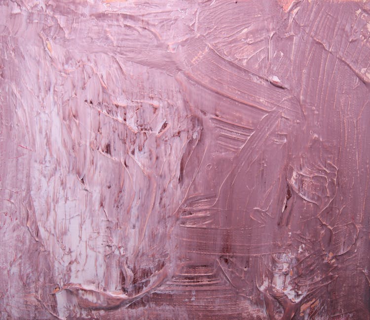 Close-up of a pink textured abstract painting with a rich, layered effect.
