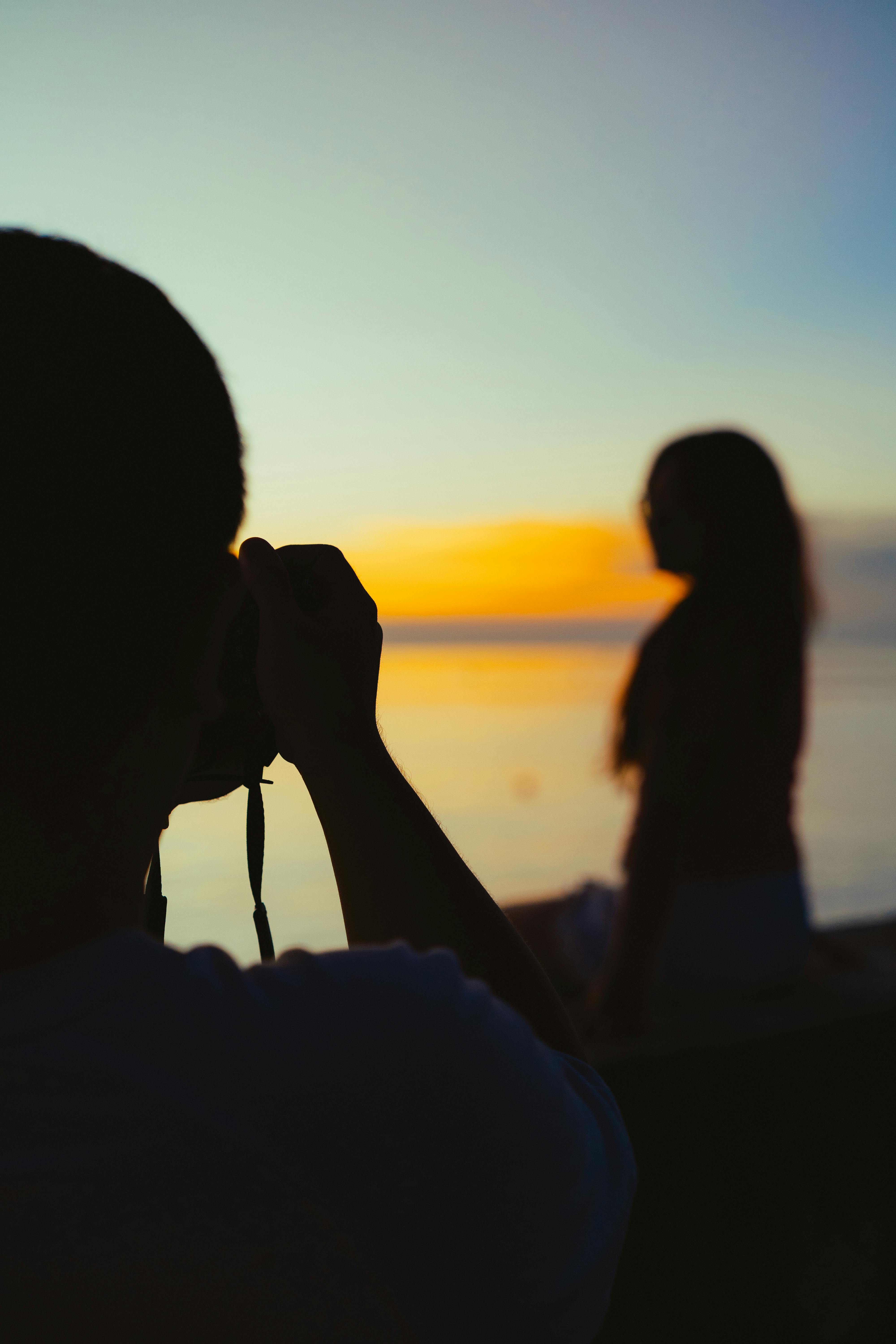Capturing a serene silhouette of photography at a stunning Vietnamese sunset beach.