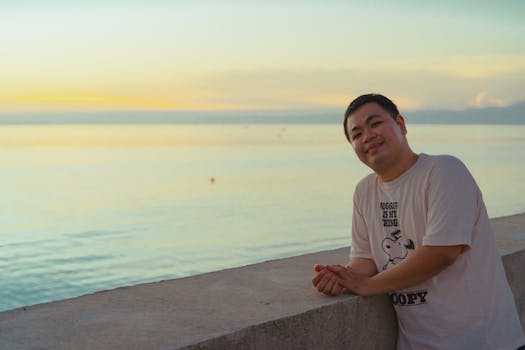 A man smiling by the beach in Bình Thuận, Vietnam during sunset. Perfect for travel and lifestyle concepts.
