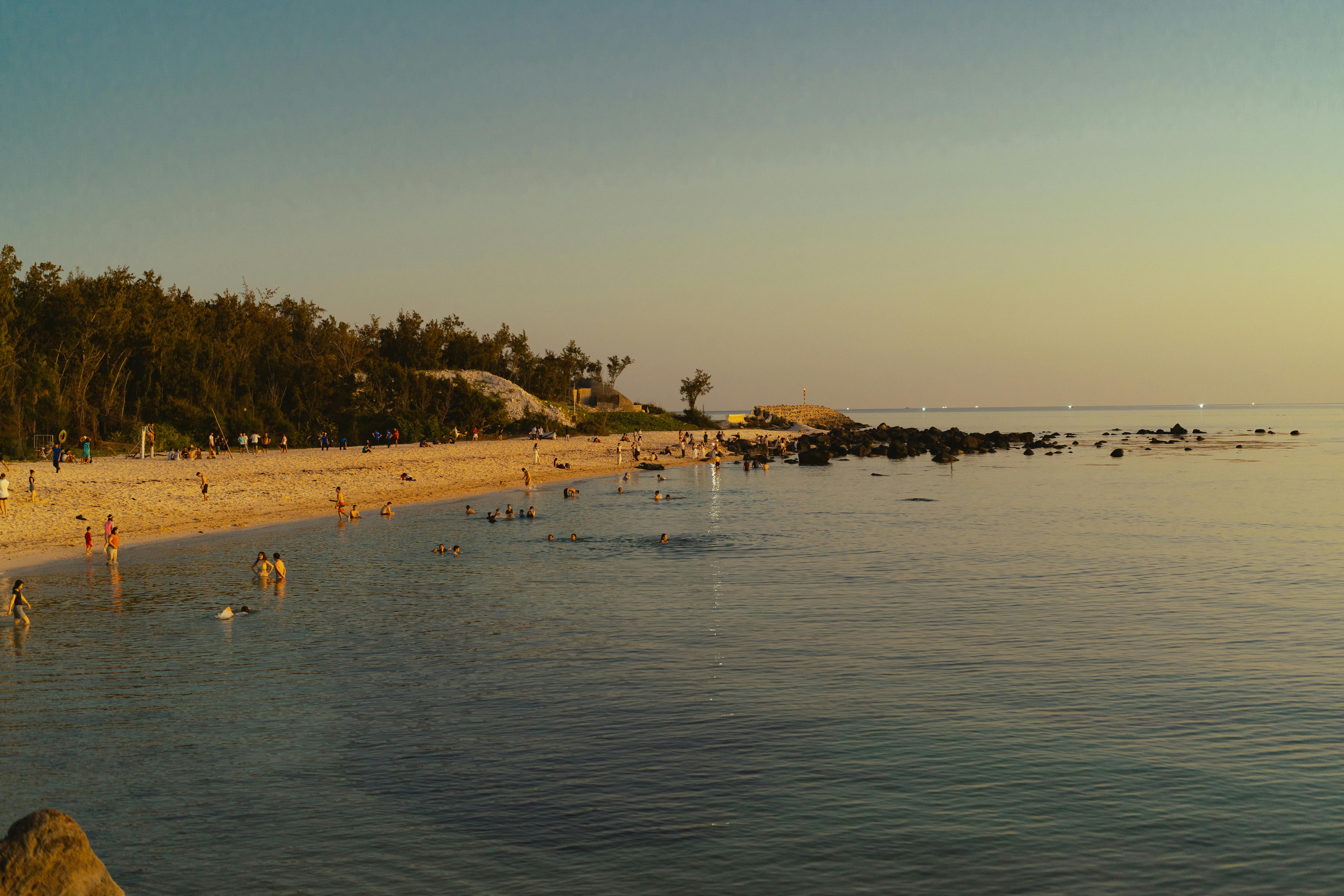 Relaxing sunset at Phu Quy Beach, Vietnam highlighting serene waters and sand.