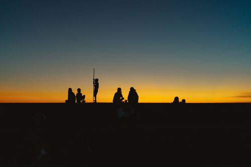 Free Silhouetted figures under a vivid sunset in Bình Thuận, Vietnam. Stock Photo