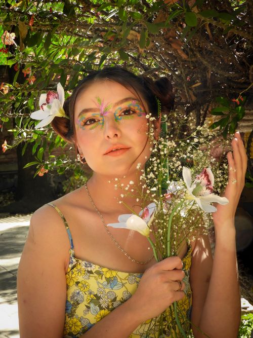 Free A woman with floral face paint and a bouquet in a spring setting, Ciudad de México. Stock Photo