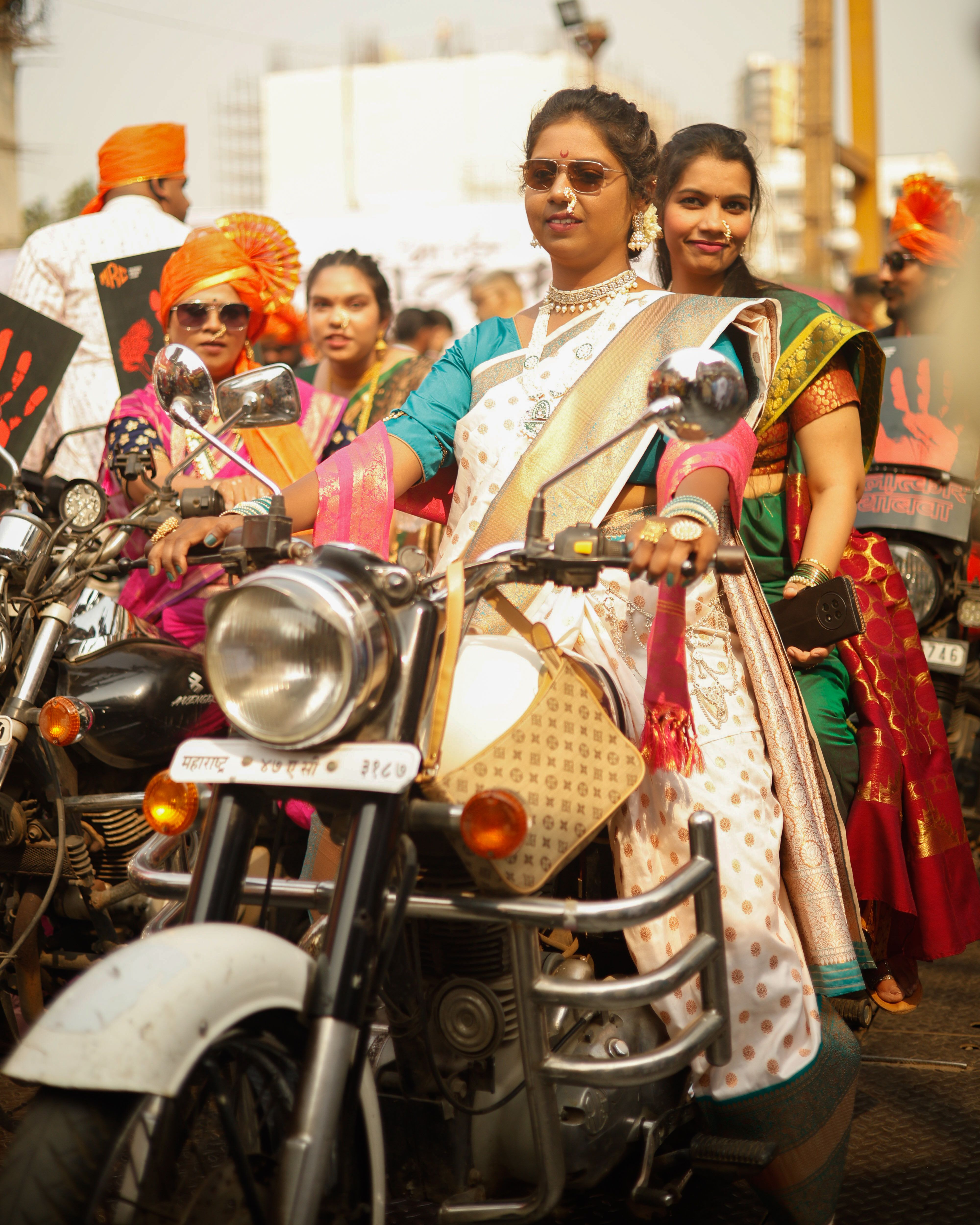 Women in Traditional Attire at Motorcycle Rally · Free Stock Photo