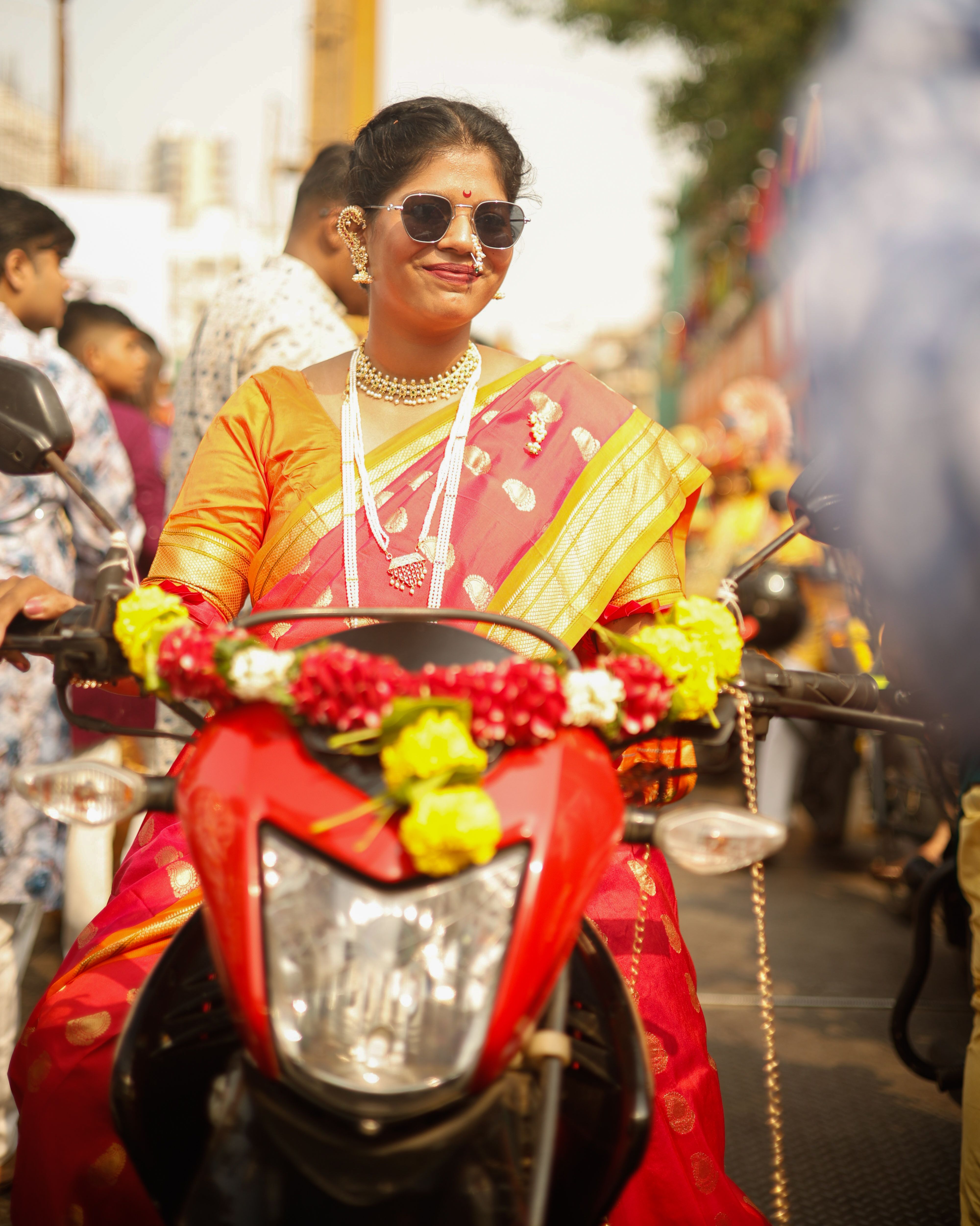Woman in Traditional Attire on Decorated Motorcycle · Free Stock Photo