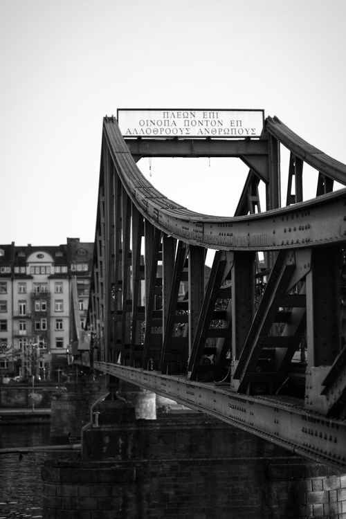 Free Black and white photo of a historic metal bridge in an urban setting. Stock Photo