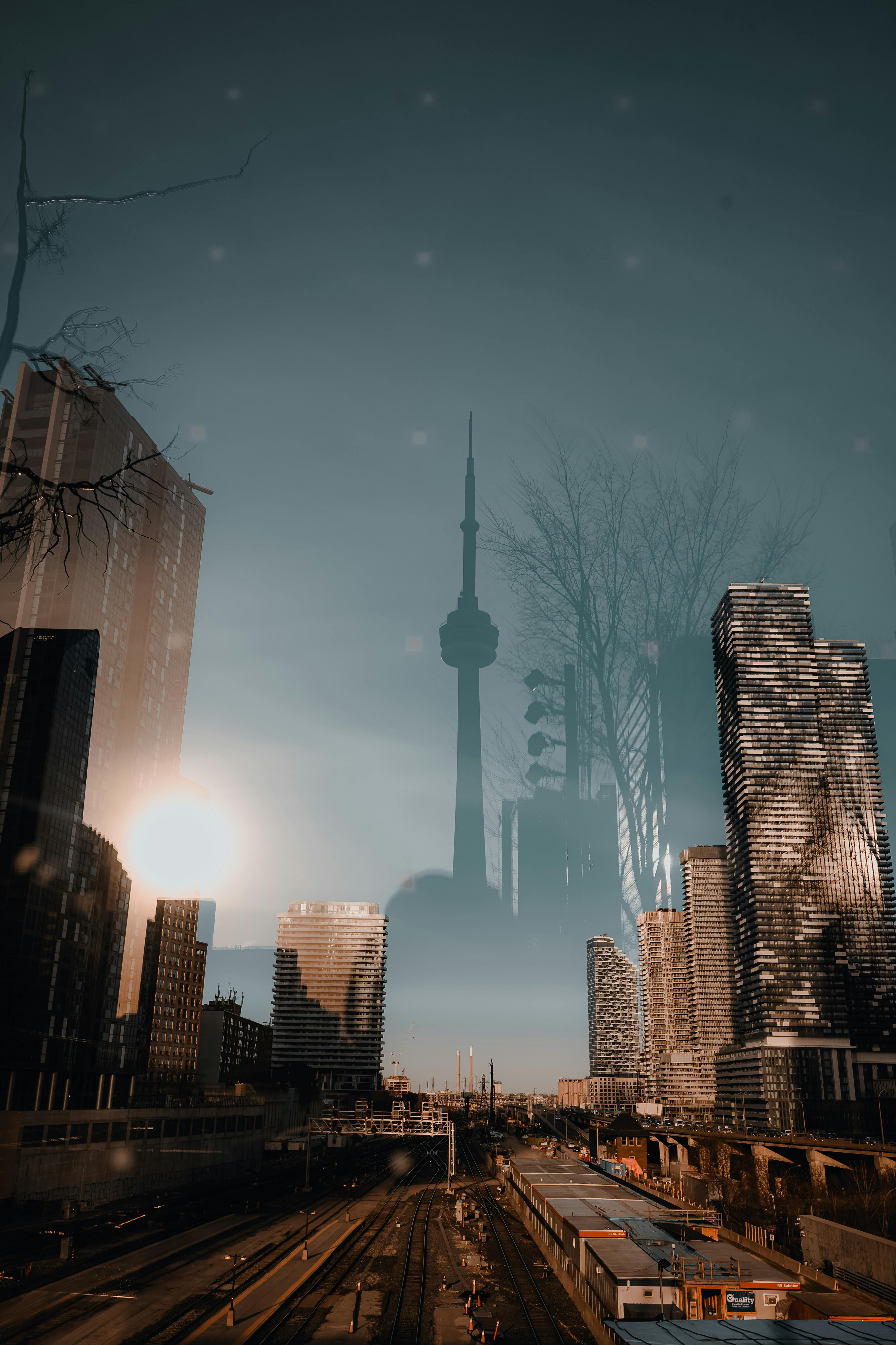 Dramatic double exposure of CN Tower and skyline at sunset.