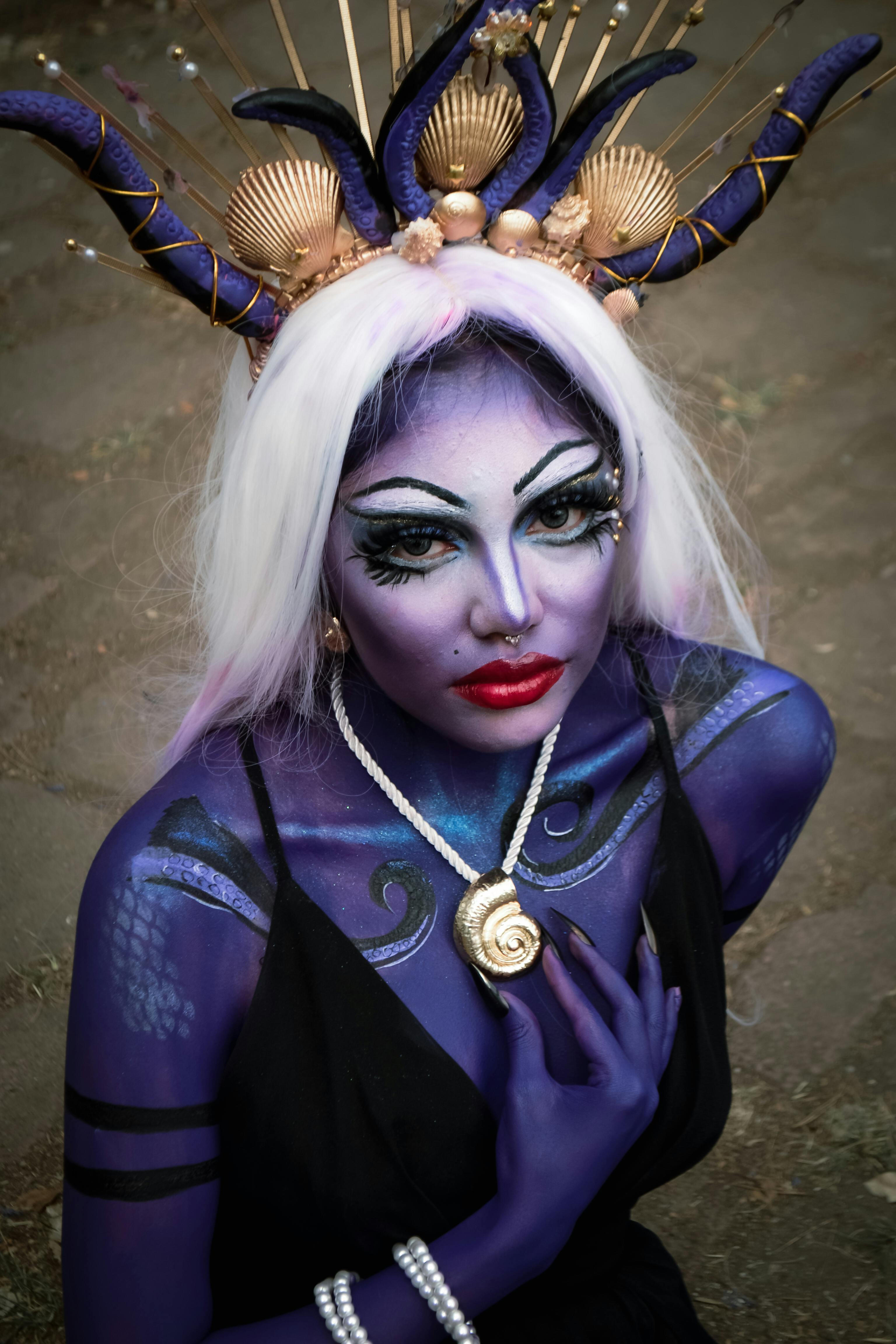 Striking fantasy cosplay portrait of a character inspired by mythical sea creatures, featuring elaborate costume and makeup.