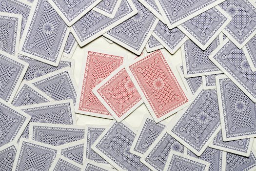 A detailed flat lay of red and blue playing cards scattered on a surface.
